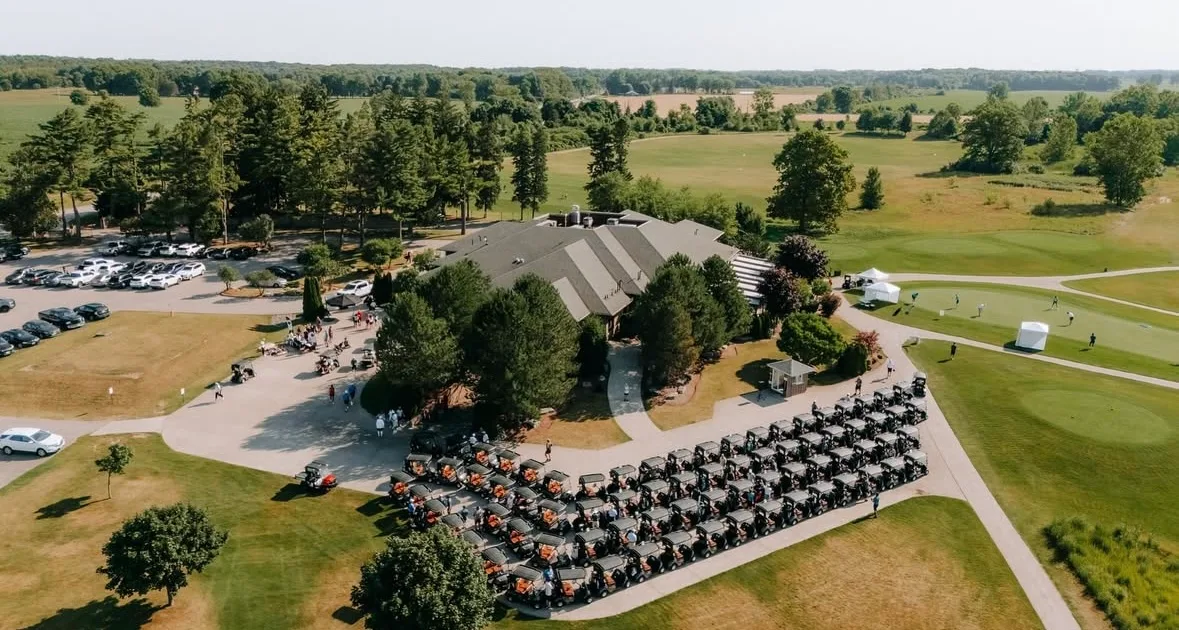 Aerial view of the FireRock clubhouse, golf carts, and surrounding course
